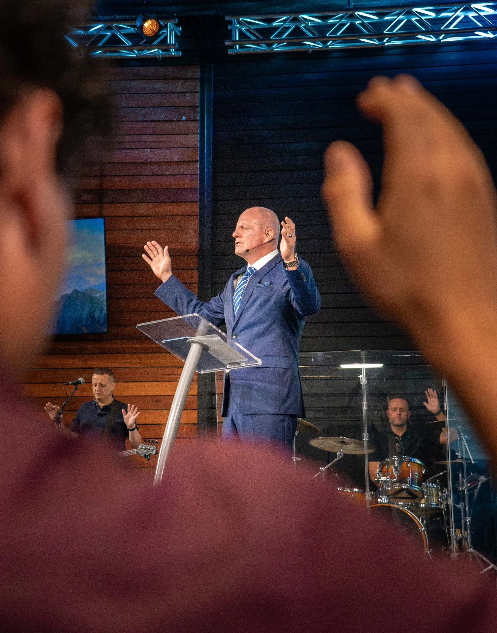 Hands raised in response at the gathering